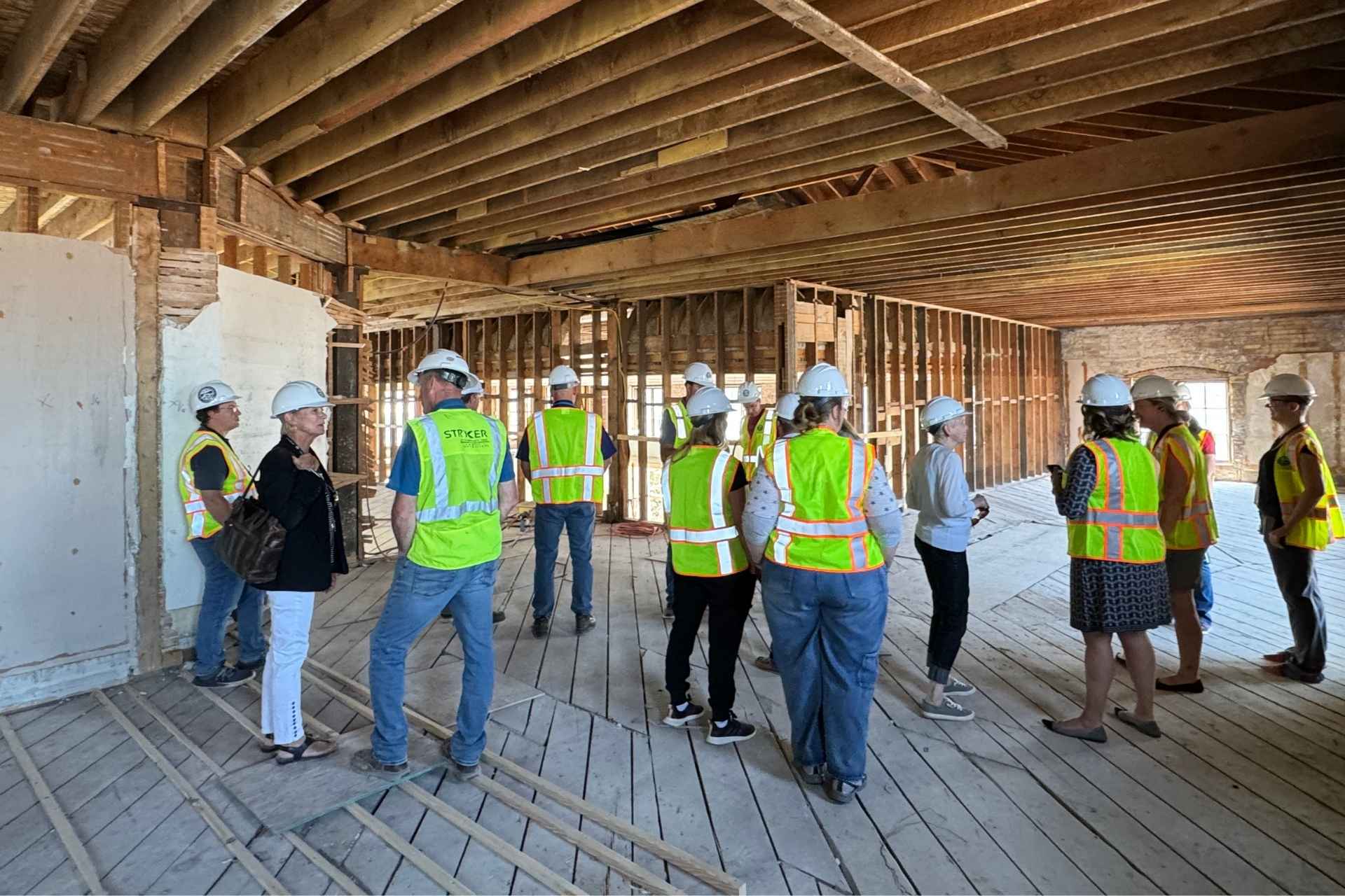 Stryker employees touring a job site under construction